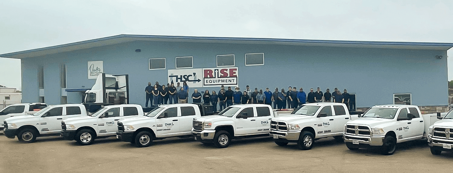 Company photo - HSC employees and fleet in front of office building